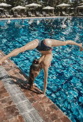 Acrobatic Handstand at the Resort Pool
